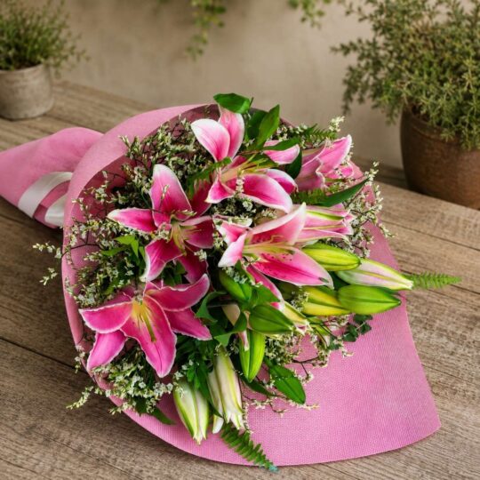 Premium pink lily bouquet with seasonal flowers and earthy wrapping for online flower delivery in Bangalore.