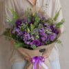Luxury European style purple flower bouquet with lisianthus, asters, seasonal blooms and rustic wrapping by FreshKnots Bangalore. Available for online flowers delivery in Bangalore.