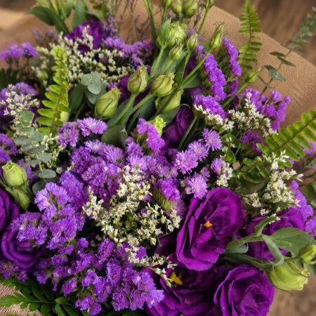 Luxury European style purple flower bouquet with lisianthus, asters, seasonal blooms and rustic wrapping by FreshKnots Bangalore. Available for online flowers delivery in Bangalore.