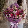 Luxury purple and magenta flower bouquet with seasonal blooms and earthy wrapping for online flower delivery in Bangalore.