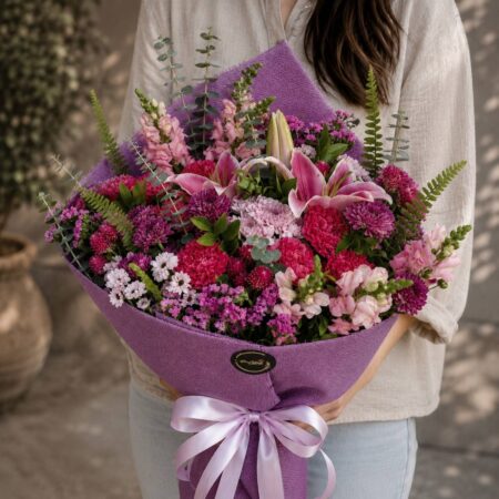 Luxury purple and magenta flower bouquet with seasonal blooms and earthy wrapping for online flower delivery in Bangalore.