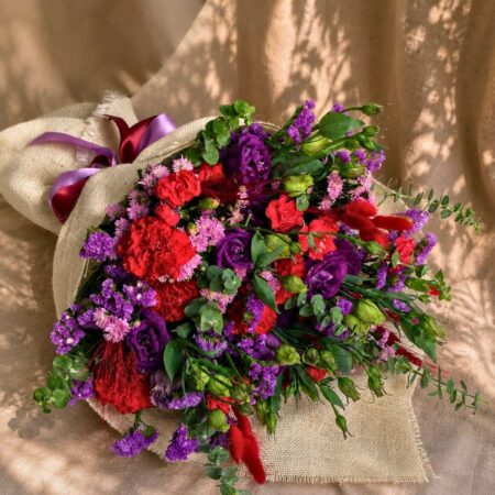 Premium pink and purple flower bouquet with seasonal blooms and elegant wrapping for online flower delivery in Bangalore.