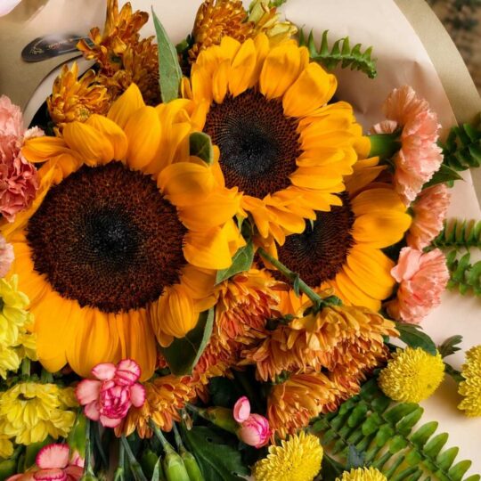 Luxury sunflower bouquet in European hand tied style with seasonal flowers and greenery by FreshKnots Bangalore. for Same Day delivery