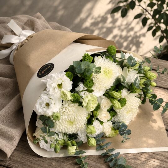 Elegant white flower bouquet with premium seasonal blooms and earthy minimalist wrapping for online flower delivery in Bangalore.