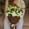 Luxury white lily bouquet in European hand tied style with fresh greenery by FreshKnots Bangalore.