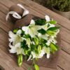 Luxury white lily bouquet in European hand tied style with fresh greenery by FreshKnots Bangalore.