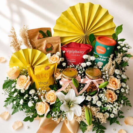 Luxury gourmet gift hamper with lilies, peach roses, healthy snacks and premium treats | Gift hamper delivery Bangalore | FreshKnots florist