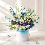 Luxury white and blue orchid hat box arrangement by FreshKnots for premium flower delivery in Bangalore.