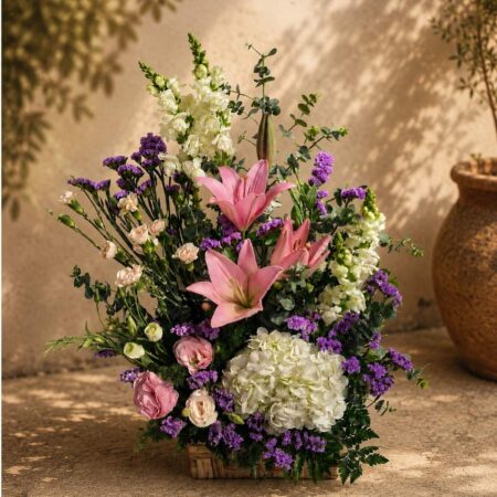 European-style flower basket with pink lilies, white hydrangeas, lisianthus and snapdragons for same-day flower delivery in Bangalore.