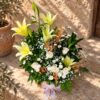Close-up of lilies, roses and wheat, Castile Gold basket Bangalore