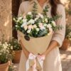 Sintra Pêche spray carnation bouquet in Bangalore with peach and white carnations and eucalyptus in kraft paper