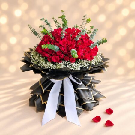 Crimson Crown 200 red roses bouquet in Bangalore with baby's breath, eucalyptus and black and gold wrapping