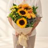 Sunflower mixed cut flowers bunch held, Bangalore