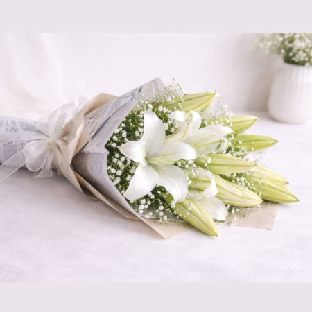White lily bouquet lying flat, Words Left Unsaid Bangalore