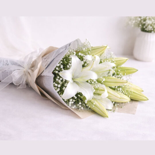 White lily bouquet lying flat, Words Left Unsaid Bangalore
