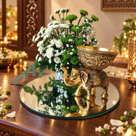 Elephant candle holder centrepiece with white Calimero and green button chrysanthemums on a mirror base, angled view