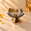Decorative glass urli bowl in Bangalore shaped like a lotus in amber textured glass on a gold metal stand