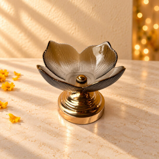 Decorative glass urli bowl in Bangalore shaped like a lotus in amber textured glass on a gold metal stand