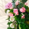 Close-up of pink spray carnations, white eustoma, pink rose, hydrangea and eucalyptus