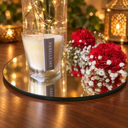 Close-up of red carnations and white baby's breath in a glass jar