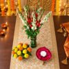 Tuberose and gladiolus vase, yellow and orange marigold vase and red rose petal urli, top view