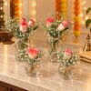 Set of four rose and baby's breath jars with jute twine bows, angled front view