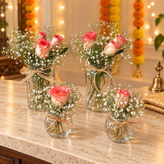 Set of four rose and baby's breath jars with jute twine bows, angled front view