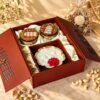 Dry fruits gift box with candle in Bangalore with cashew and pistachio jars and a scented gold urli candle in a jharokha box
