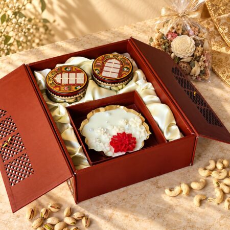 Dry fruits gift box with candle in Bangalore with cashew and pistachio jars and a scented gold urli candle in a jharokha box