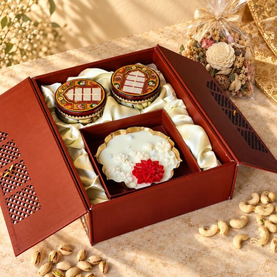 Dry fruits gift box with candle in Bangalore with cashew and pistachio jars and a scented gold urli candle in a jharokha box