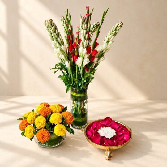 Diwali urli decoration in Bangalore with a tuberose and gladiolus vase, a marigold matki vase and a metal urli of red rose petals with candle