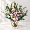 Pink flowers in vase in Bangalore with pink roses, lisianthus, spray carnations and eucalyptus in a glass fishbowl vase