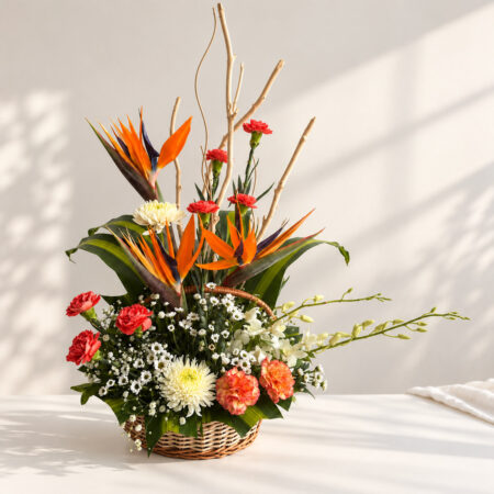 Exotic flower basket in Bangalore with bird of paradise, orchids, carnations and white chrysanthemums in a cane basket