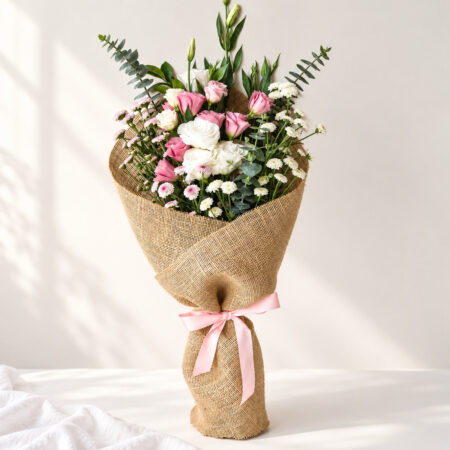 Exotic flower bunch in Bangalore with white and pink lisianthus, calimero chrysanthemums and eucalyptus in natural jute wrap