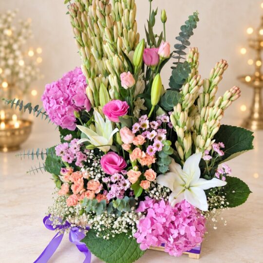 Fragrant exotic flower arrangement in a wooden crate with purple ribbon, front view