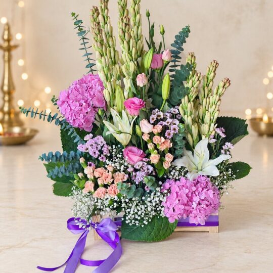 Exotic flower arrangement in Bangalore with tuberose, pink hydrangea, oriental lily and eustoma in a wooden crate