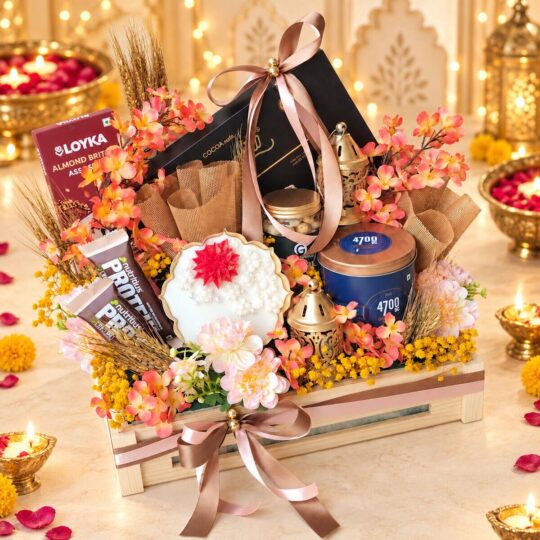 Wooden crate Diwali hamper with urli candle, gold lanterns, popcorn tin and chocolates, front view