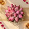 Lotus flowers for Lakshmi Puja in Bangalore with 16 pink lotus buds and baby’s breath in a cane basket, top view