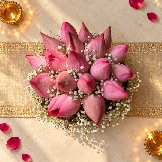 Lotus flowers for Lakshmi Puja in Bangalore with 16 pink lotus buds and baby’s breath in a cane basket, top view