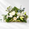 White flower arrangement in Bangalore with fragrant oriental lilies, eustoma and chrysanthemum in a woven coconut leaf base