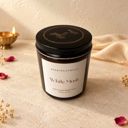Scented candle in amber glass jar with gold Light & Love lid print, angled view