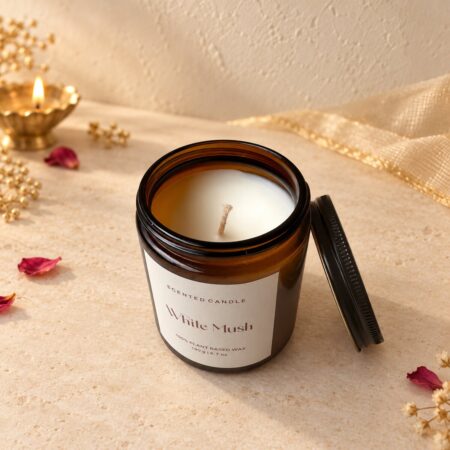 Amber glass candle jar opened to show the cream plant-based wax and wick, angled view
