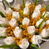White tulip shaped candles with dried mustard baby's breath, close-up