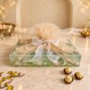 Mint lotus-print dry fruits hamper wrapped in champagne tulle with pearl beads and a white organza bow