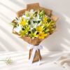 Bright Side yellow lily bouquet in Bangalore with white lilies, baby's breath and a jute wrap tied with white ribbon
