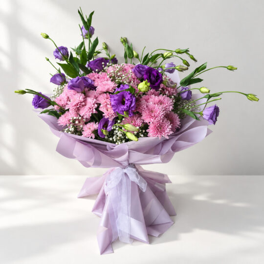 Purple lisianthus bouquet in Bangalore with pink chrysanthemums and baby's breath in lilac wrap
