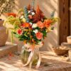 Ronda Sunset orange flower arrangement in Bangalore with carnations, celosia and trailing amaranthus in a glass jar vase