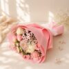 Pastel pink and white roses, carnations and chrysanthemums with baby's breath, side view
