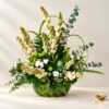 Diwali tuberose centrepiece in Bangalore with fragrant tuberoses and mixed greens in a handwoven coconut leaf basket