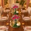 Two carnation mirror centrepieces with lanterns and rose candles shown for scale, wide view